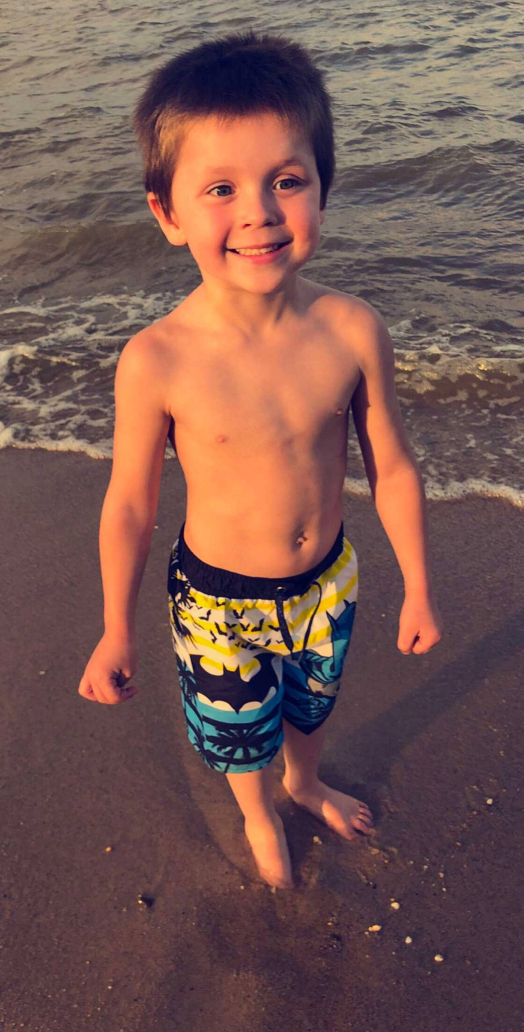 Brayden is registered to the contest to win money with this photo: barechested, barefoot, beach, board_short, chest, child, fun, joy, muscle, person, play, sand, sea, shorts, smile, standing, summer, swimwear, toddler, trunk