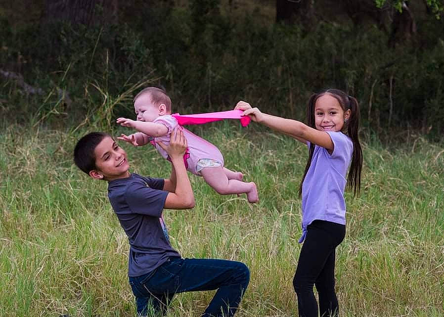 Brooklyn is registered to the contest to win money with this photo: event, face, flash_photography, fun, gesture, grass, grassland, happy, joy, leisure, meadow, people_in_nature, person, plant, prairie, recreation, shirt, shorts, smile, sneakers
