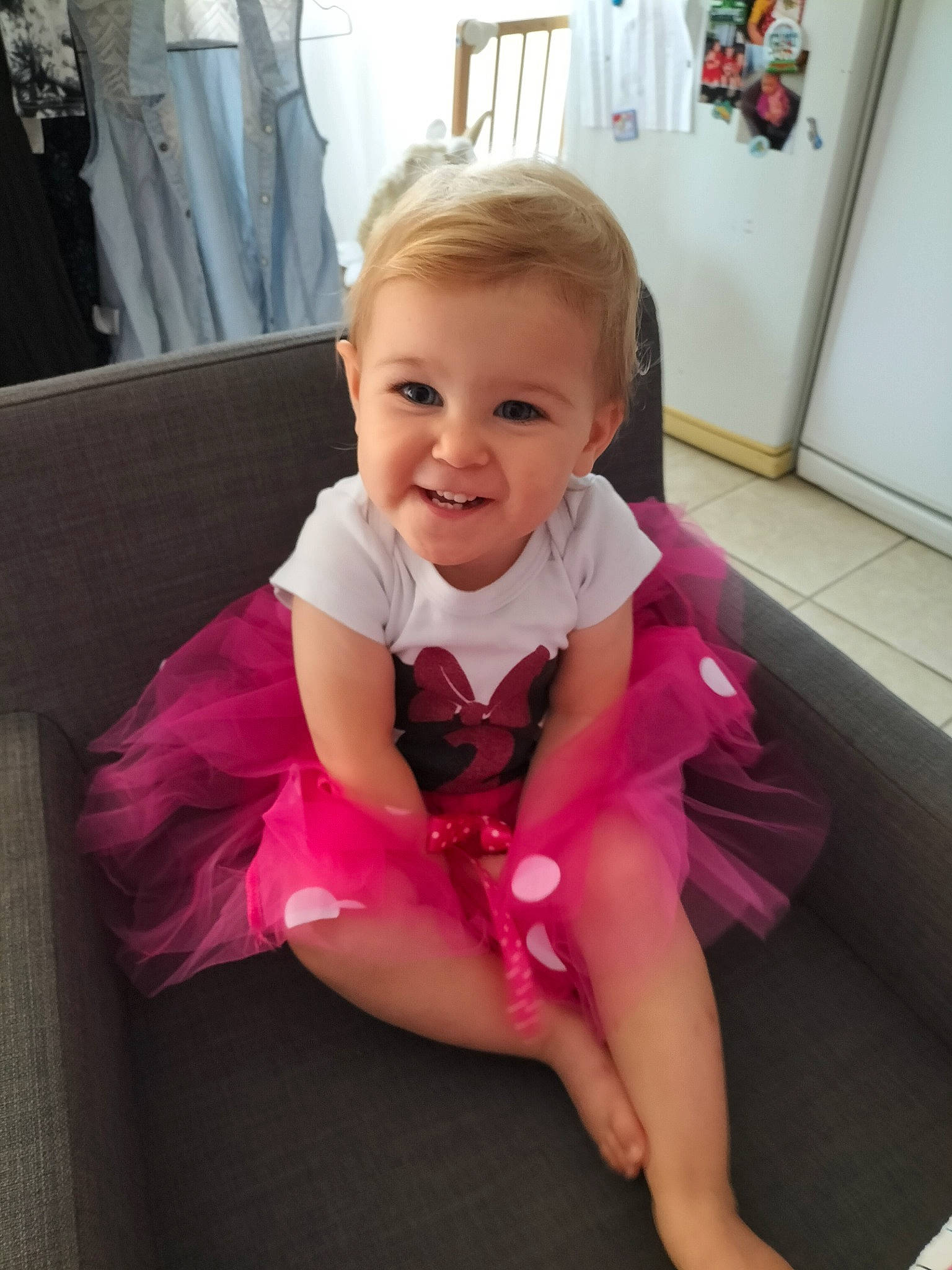Mia participe au concours pour gagner de l'argent avec cette photo : baby, baby_toddler_clothing, beauty, cheek, child, comfort, dress, eye, floor, fun, happy, iris, joy, magenta, person, pink, purple, skin, sleeve, smile