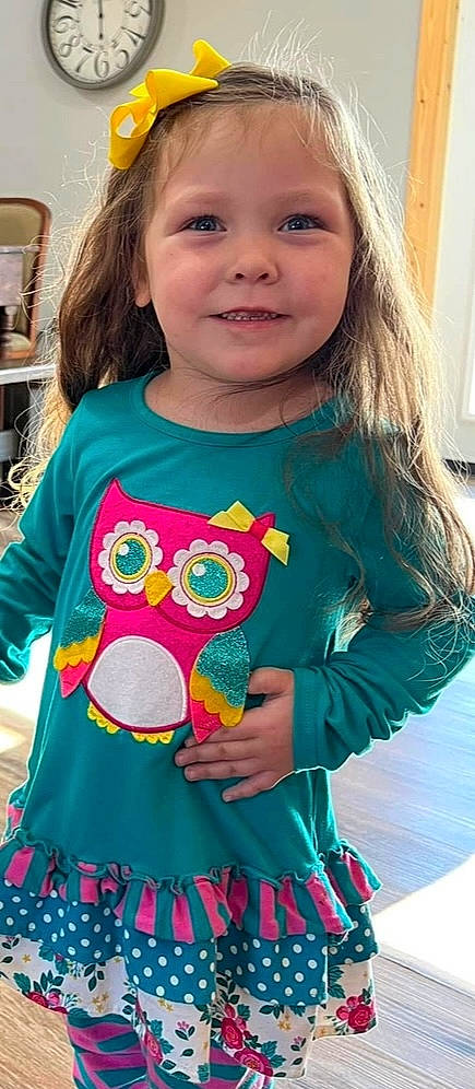 Lily is registered to the contest to win money with this photo: aqua, azure, baby_toddler_clothing, clothing, green, hairstyle, happy, head, joy, neck, outerwear, person, pink, skin, sleeve, smile, standing, t_shirt, textile, toddler