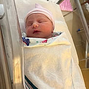 Jagger is registered to the contest to win money with this photo: newborn, baby, infant, sleeping, hospital, bassinet, blanket, swaddled, hat, face, peaceful, indoors, bed, person, cute, resting, soft, newborn_care, wrapped, healthcare