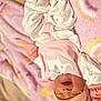 baby, infant, sleepwear, pajamas, pink, white, blanket, soft, cute, newborn, child, lying_down, hat, smiling, mouth_open, cozy, resting, indoors, person, portrait