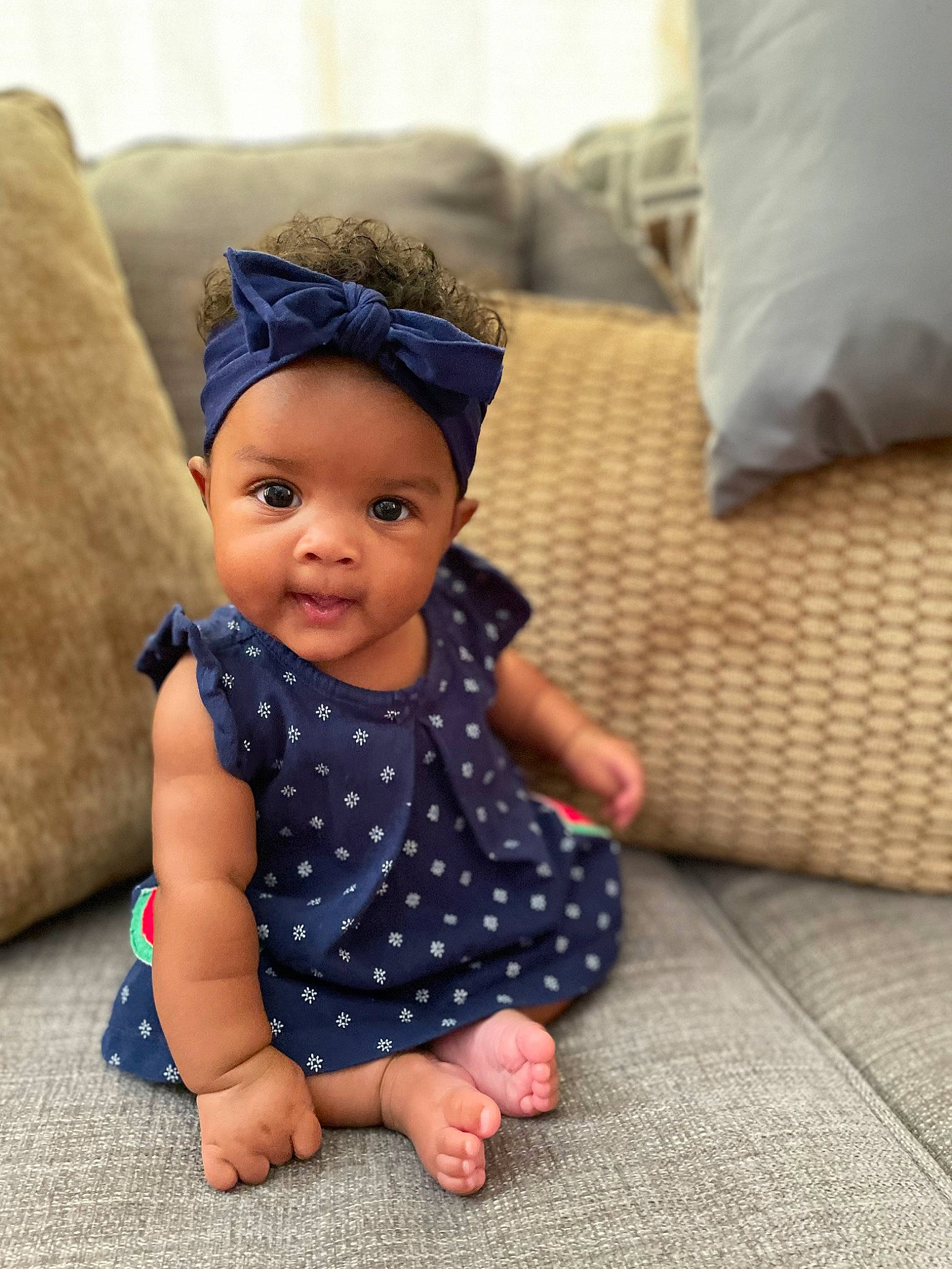 Jaiden is registered to the contest to win money with this photo: baby, baby_toddler_clothing, cap, child, comfort, electric_blue, eye, face, floor, flooring, fun, hairstyle, head, headwear, pattern, person, sitting, skin, sleeve, textile