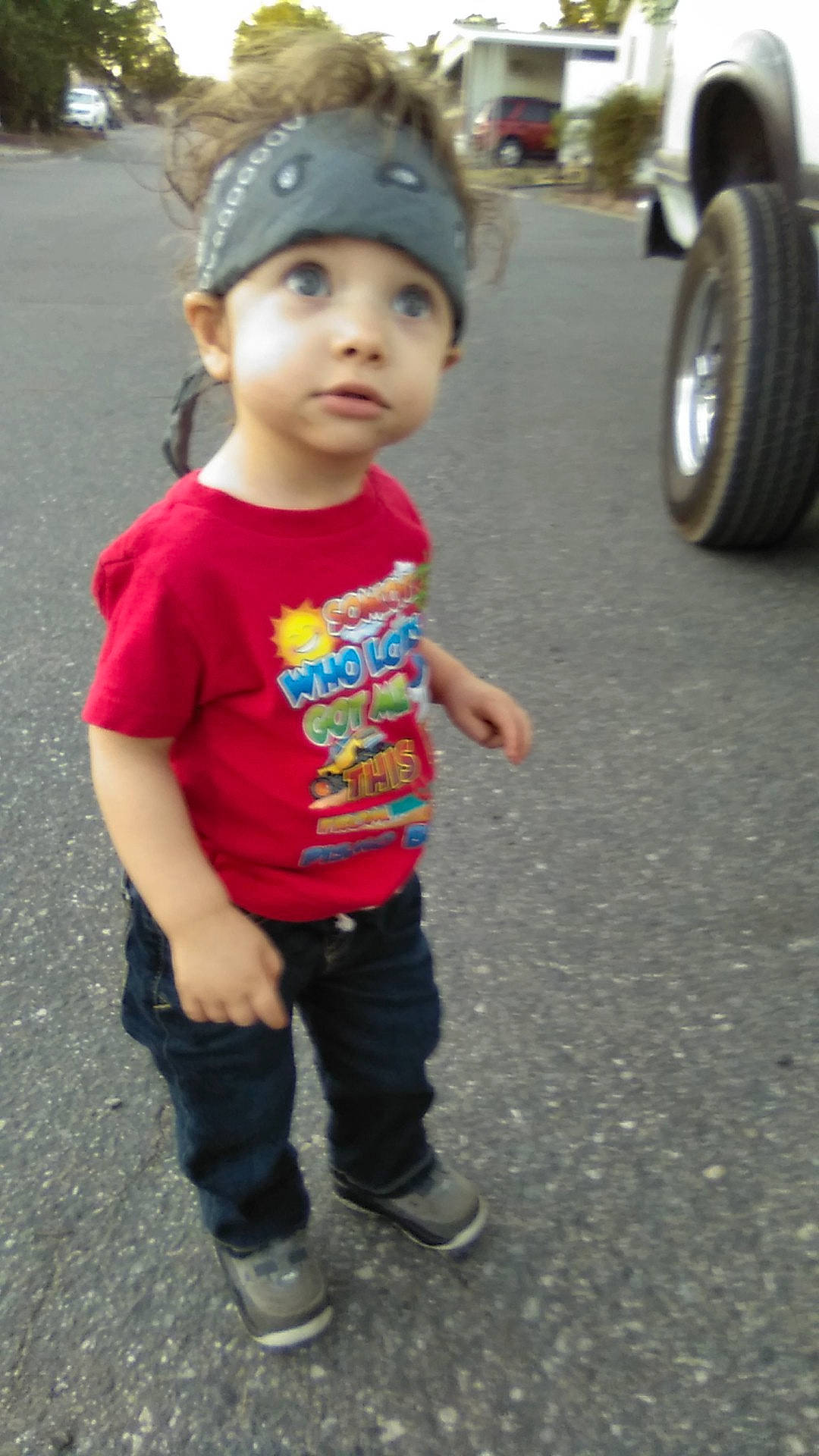 Jessie joined the competition — help win amazing prizes! asphalt, automotive_tire, baby, cap, cool, face, happy, hat, head, headwear, leg, people, person, photograph, sleeve, snapshot, standing, t_shirt, tire, toddler