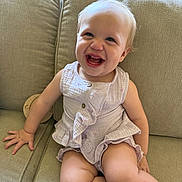 Zaria joined the competition — help win amazing prizes! baby, button, child, clothing, couch, cute, face, furniture, hair, hand, happy, indoors, infant, leg, light, portrait, ruffles, sitting, skin, smiling