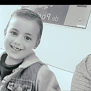 Thiago participe au concours pour gagner de l'argent avec cette photo : child, boy, smile, missing_tooth, denim_jacket, hoodie, face, portrait, monochrome, indoor, wall, sign, casual_clothing, happy, young, person, head_and_shoulders, expression, friendly, cute