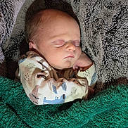 August joined the competition — help win amazing prizes! newborn, baby, sleeping, infant, portrait, face, closed_eyes, blanket, swaddled, cozy, fuzzy, textile, indoors, cuddled, peaceful, resting, clothing, patterned, soft, photography