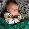 newborn, baby, sleeping, infant, portrait, face, closed_eyes, blanket, swaddled, cozy, fuzzy, textile, indoors, cuddled, peaceful, resting, clothing, patterned, soft, photography