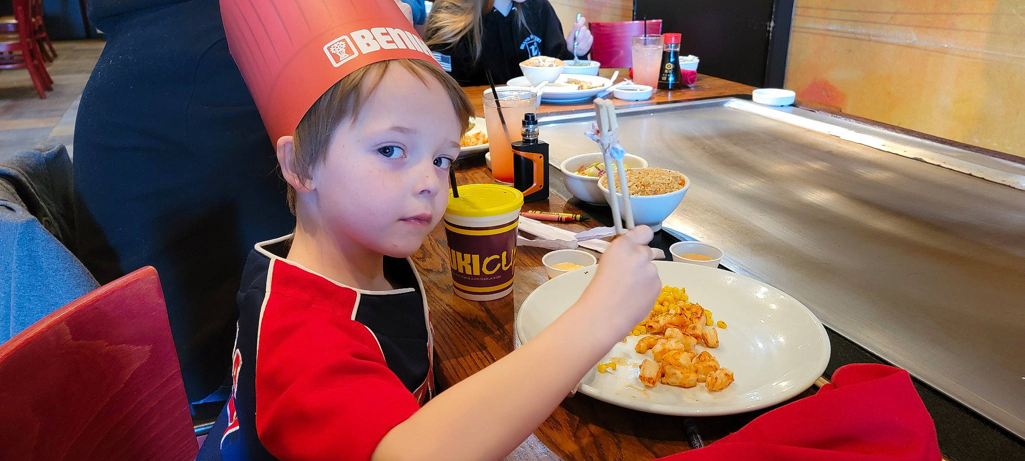 Steven joined the competition — help win amazing prizes! baseball_cap, cap, chair, child, cuisine, dish, event, fast_food, food, food_craving, fun, hat, ingredient, orange, person, plate, recipe, sharing, table, tableware