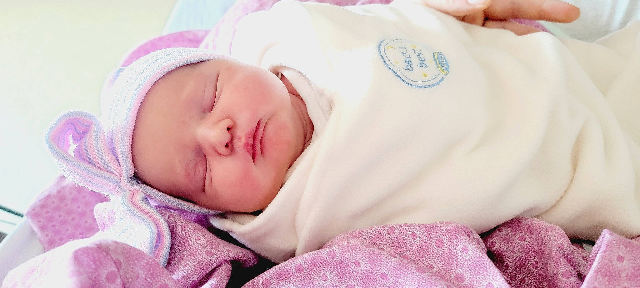 Shannon is registered to the contest to win money with this photo: baby, baby_products, baby_sleeping, baby_toddler_clothing, bedtime, cheek, child, chin, comfort, eyelash, face, finger, happy, headwear, linens, nap, nose, person, pink, skin