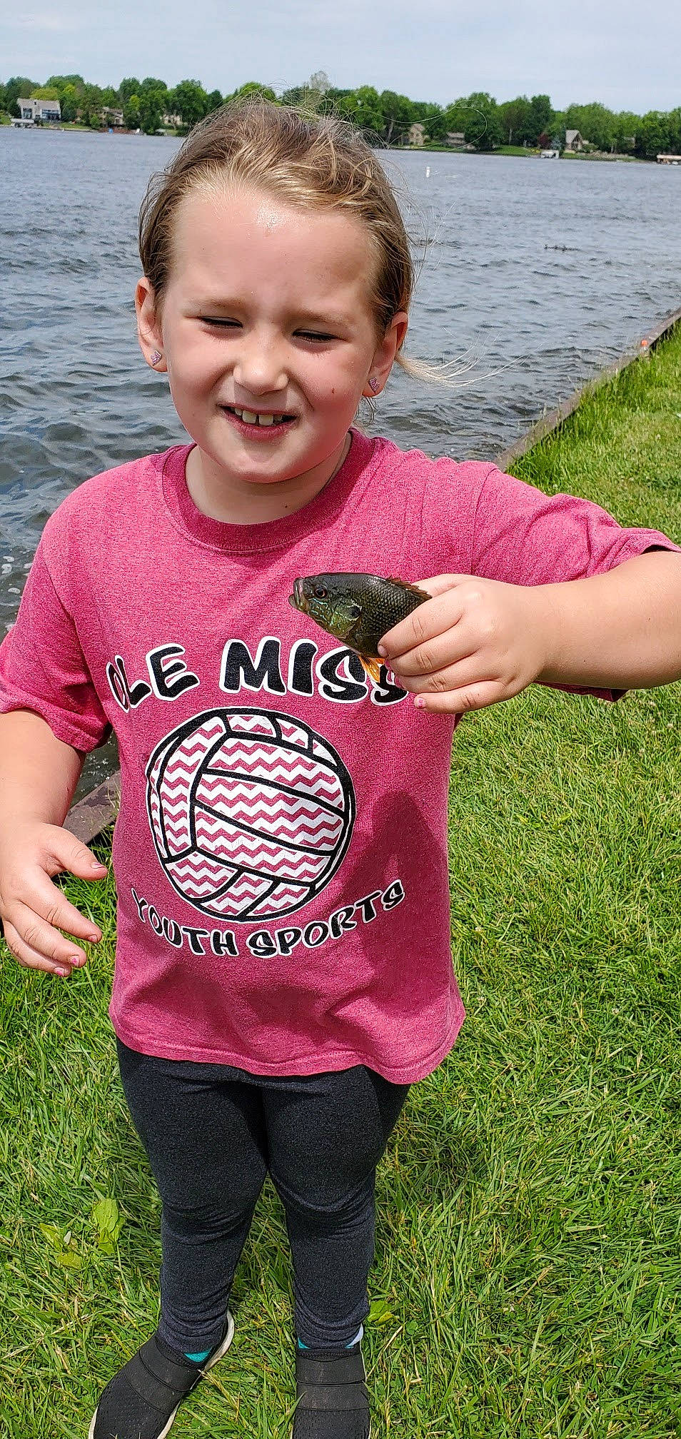 Jacee is registered to the contest to win money with this photo: baby_toddler_clothing, child, finger, fish, fun, gesture, grass, hairstyle, happy, joy, magenta, pattern, people_in_nature, person, pink, play, sleeve, smile, t_shirt, thumb