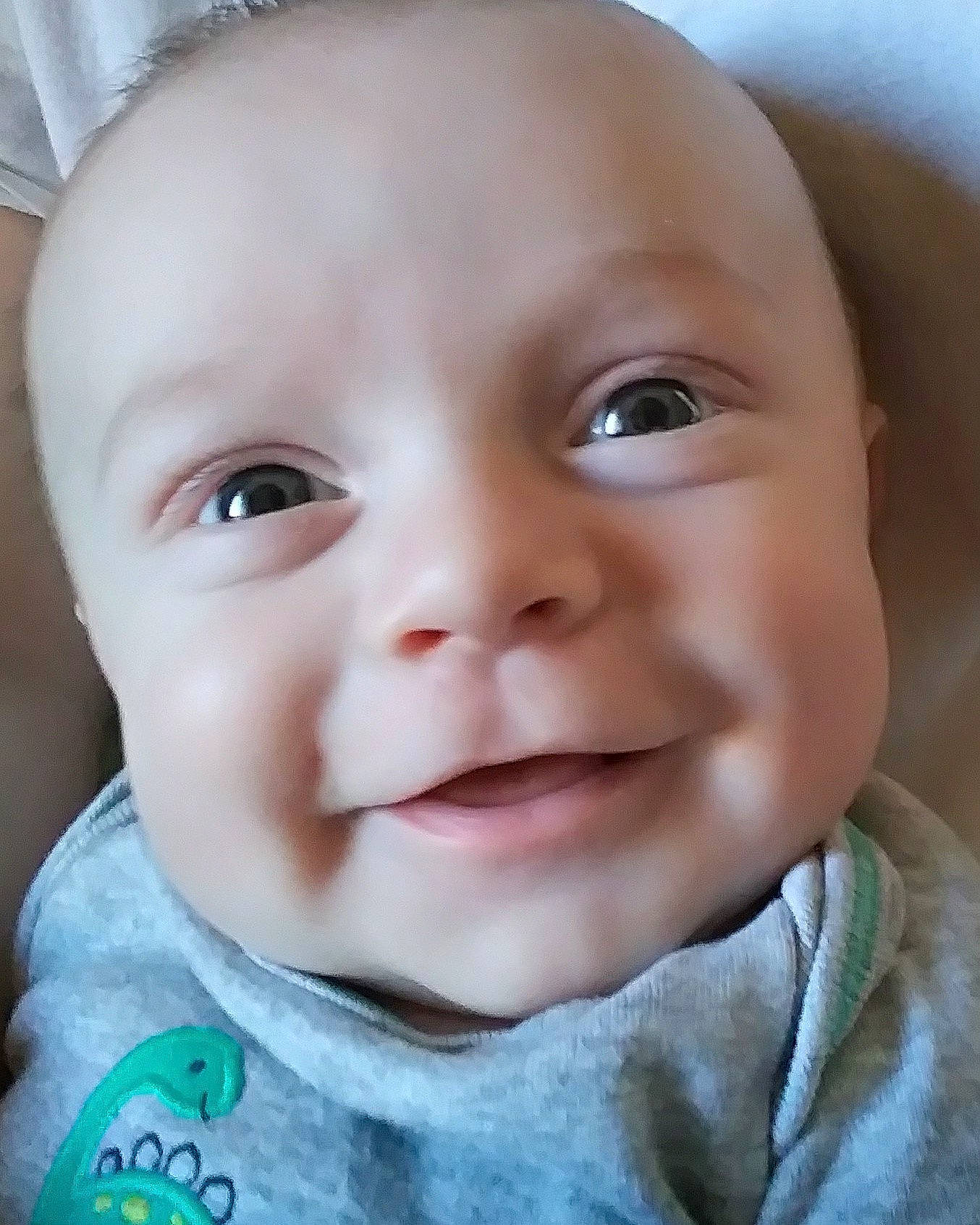 Landen is registered to the contest to win money with this photo: cheek, child, chin, close_up, eye, eyebrow, face, facial_expression, forehead, head, infant, iris, laughter, lip, mouth, nose, person, skin, smile, toddler