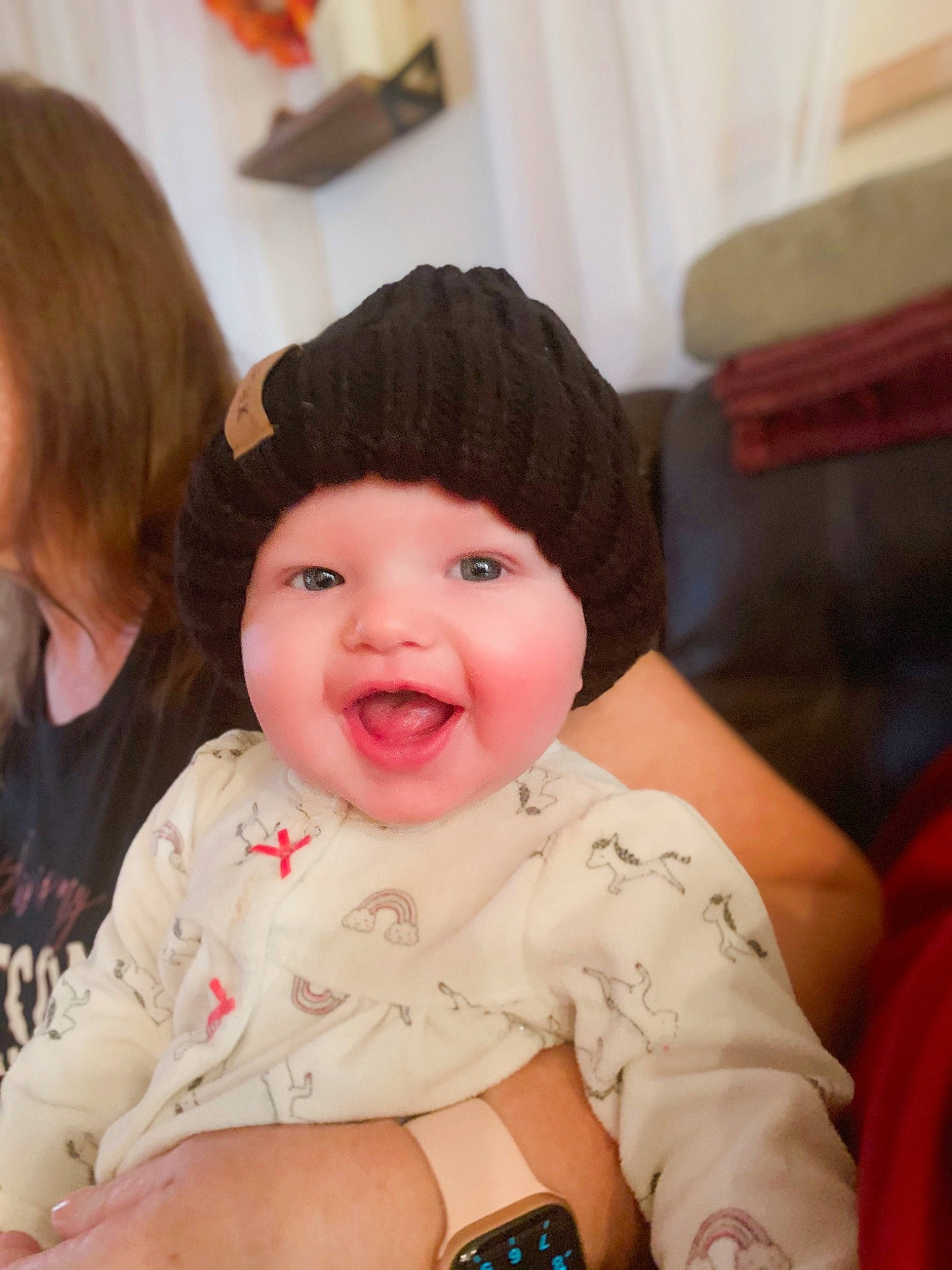 Wednesday is registered to the contest to win money with this photo: baby, beauty, cheek, child, ear, eye, face, facial_expression, fashion_accessory, fun, head, headgear, headwear, iris, lip, person, sitting, skin, smile, toddler