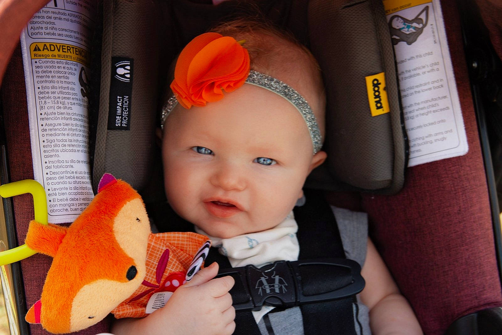 Wednesday is registered to the contest to win money with this photo: baby, baby_carriage, baby_products, cap, child, ear, headgear, headwear, orange, person, product, toddler