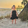 barefoot, beach, black_dress, child, coast, curly_hair, grass, happy, holiday, nature, outdoor, portrait, sand, scenic, smile, summer, sunlight, sunset, vacation, young_girl