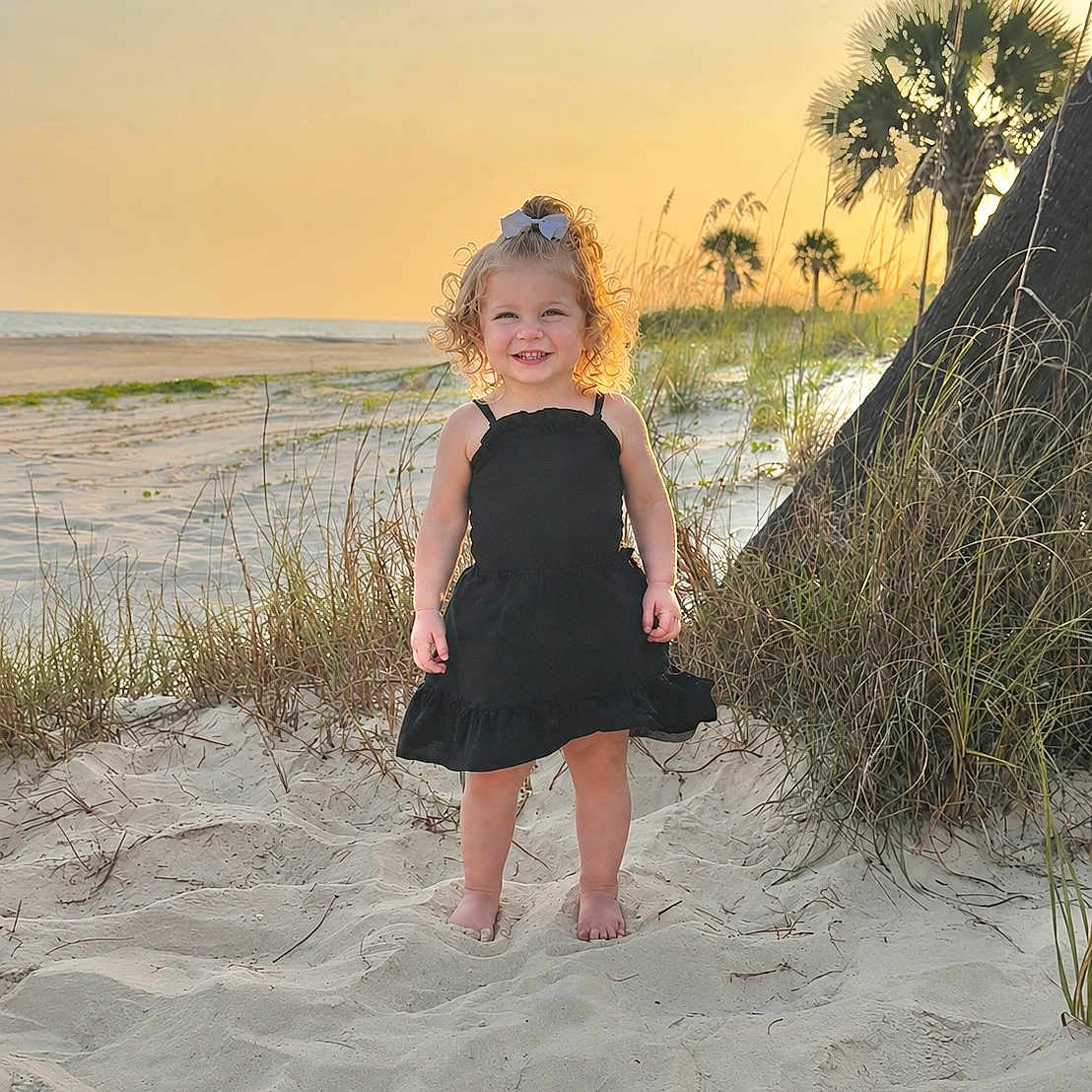 Morghan Graham joined the competition — help win amazing prizes! barefoot, beach, black_dress, child, coast, curly_hair, grass, happy, holiday, nature, outdoor, portrait, sand, scenic, smile, summer, sunlight, sunset, vacation, young_girl