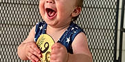 Ripp joined the competition — help win amazing prizes! baby, child, smiling, happy, sitting, plaque, wooden, holding, clothing, stars, stripes, red, white, blue, metal_chair, pattern, face, portrait, indoors, cute