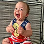 baby, child, smiling, happy, sitting, plaque, wooden, holding, clothing, stars, stripes, red, white, blue, metal_chair, pattern, face, portrait, indoors, cute