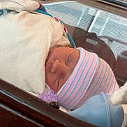 Zaylee joined the competition — help win amazing prizes! architecture, baby, bed, blanket, bonnet, building, clothing, cradle, crib, cushion, face, furniture, glove, hat, head, hospital, infantbed, newborn, person, sleeping