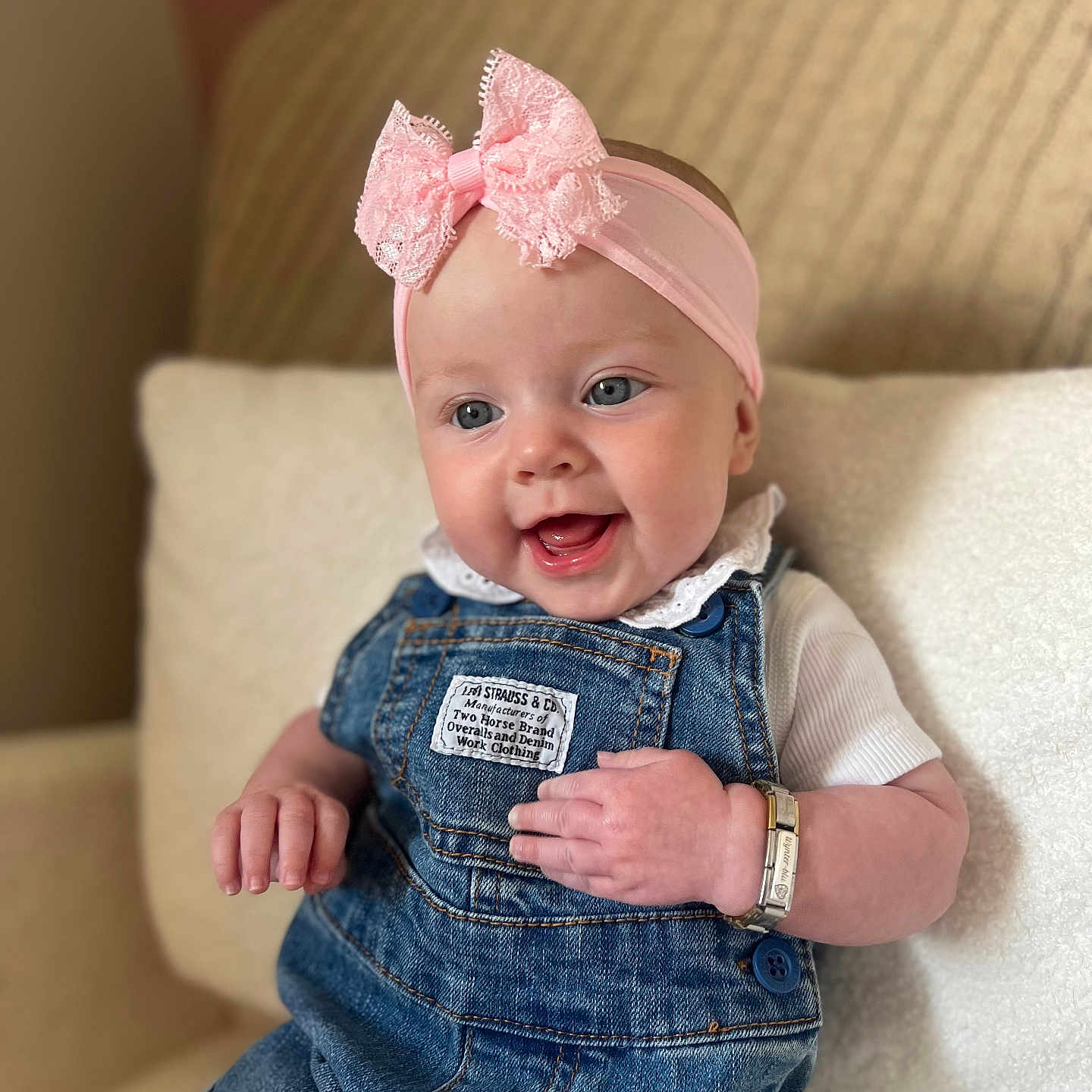 Wynter-Blu is registered to the contest to win money with this photo: baby, blue_eyes, bracelet, child, clothing, couch, cute, denim_overalls, hand, happy, headband, indoor, infant, pink_bow, portrait, sitting, skin, smile, white_shirt, young