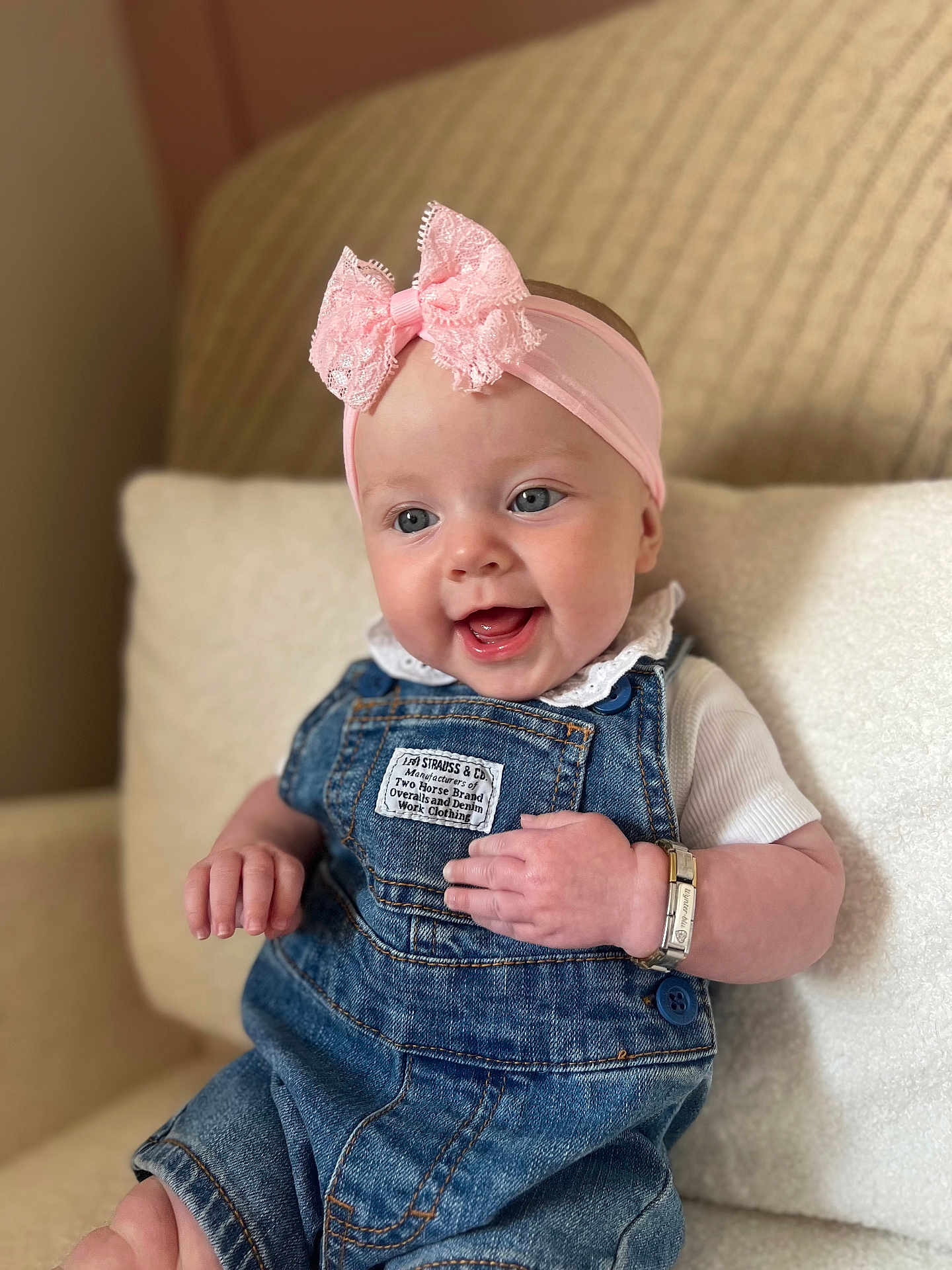 Wynter-Blu is registered to the contest to win money with this photo: baby, blue_eyes, bracelet, child, clothing, couch, cute, denim_overalls, hand, happy, headband, indoor, infant, pink_bow, portrait, sitting, skin, smile, white_shirt, young