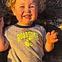 Nixon joined the competition — help win amazing prizes! toddler, child, smiling, curly_hair, blonde, tshirt, dinosaur_graphic, sunlight, outdoor, rock, happy, portrait, cute, young_child, face, person, casual_clothing, playful, nature, fun