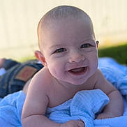 Preston joined the competition — help win amazing prizes! baby, smiling, blue_blanket, outdoor, grass, infant, happy, face, skin, cheeks, eyes, hand, bare_chest, person, portrait, young_child, lying_down, daylight, nature, closeup