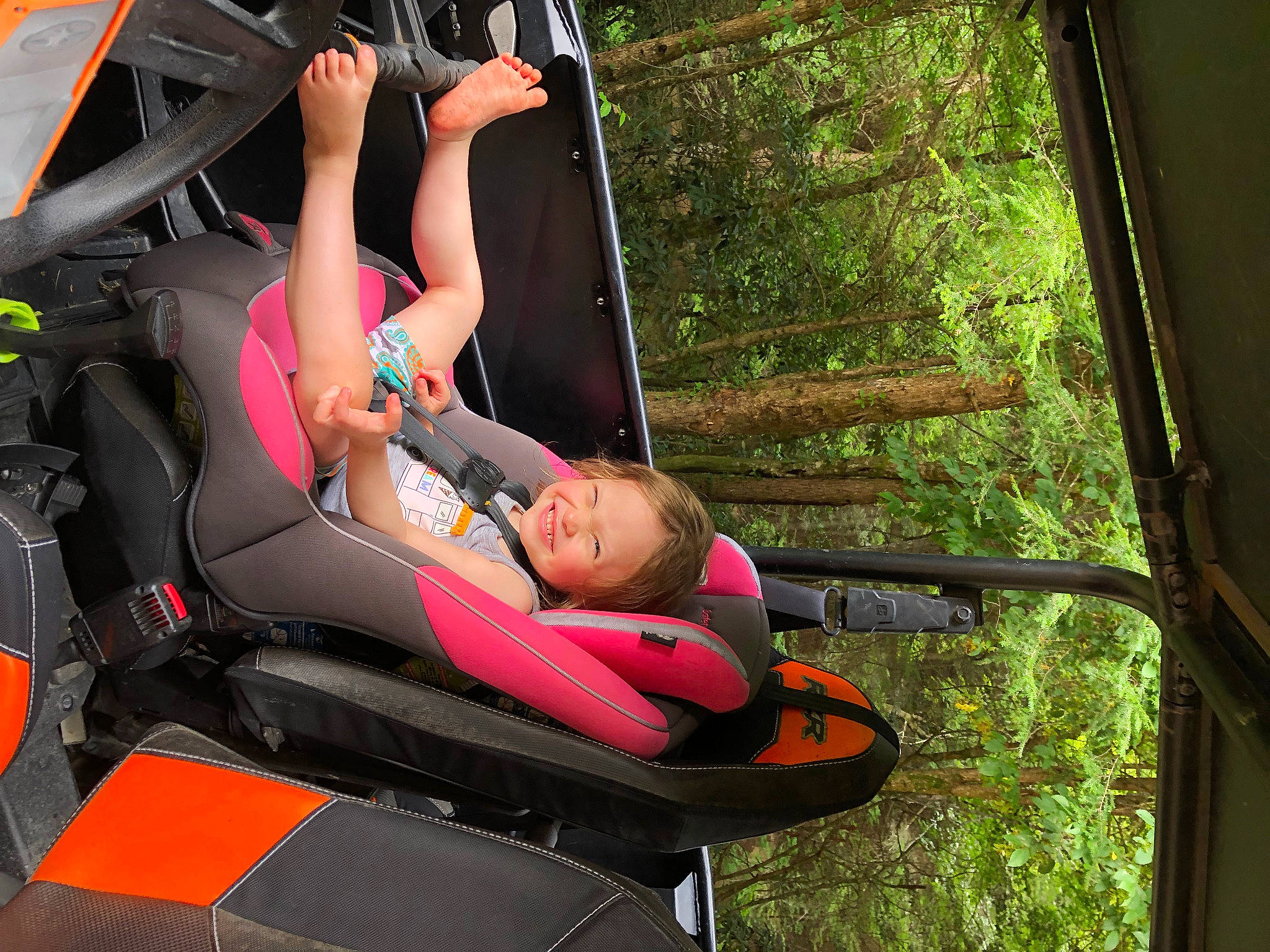 Zoey Taylor joined the competition — help win amazing prizes! adventure, auto_part, automotive_exterior, comfort, fun, grass, human_leg, lap, leg, leisure, motor_vehicle, person, recreation, sandal, shorts, sitting, thigh, tire, tree, vacation