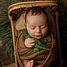 baby, sleeping, wicker_basket, knit_blanket, plush_toy, green_plush, cozy, infant, peaceful, wrapped, cute, soft_texture, foot, hand, portrait, indoors, baby_boy, child, resting, newborn