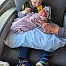 child, newborn, baby, chair, blanket, person, hand, window, sneakers, clothing, indoor, family, love, tenderness, portrait, seated, infant, holding, hospital, parent