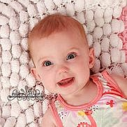 Elizabeth joined the competition — help win amazing prizes! baby, infant, child, smiling, portrait, close_up, lying_down, blanket, pink, white, fluffy, baby_clothing, floral_pattern, indoors, photography, face, eyes, red_hair, happy, watermark