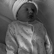 Oakleigh-May is registered to the contest to win money with this photo: baby, sleeping, hat, pom_pom, blanket, onesie, heart_pattern, infant, cozy, soft, bed, rest, cute, warm, face, clothing, newborn, portrait, peaceful, monochrome