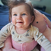 Daisy is registered to the contest to win money with this photo: baby, child, blue_eyes, smiling, hair, pink, plush, seat, indoor, soft_toys, cute, happy, clothing, infant, face, person, toddler, comfort, portrait, window