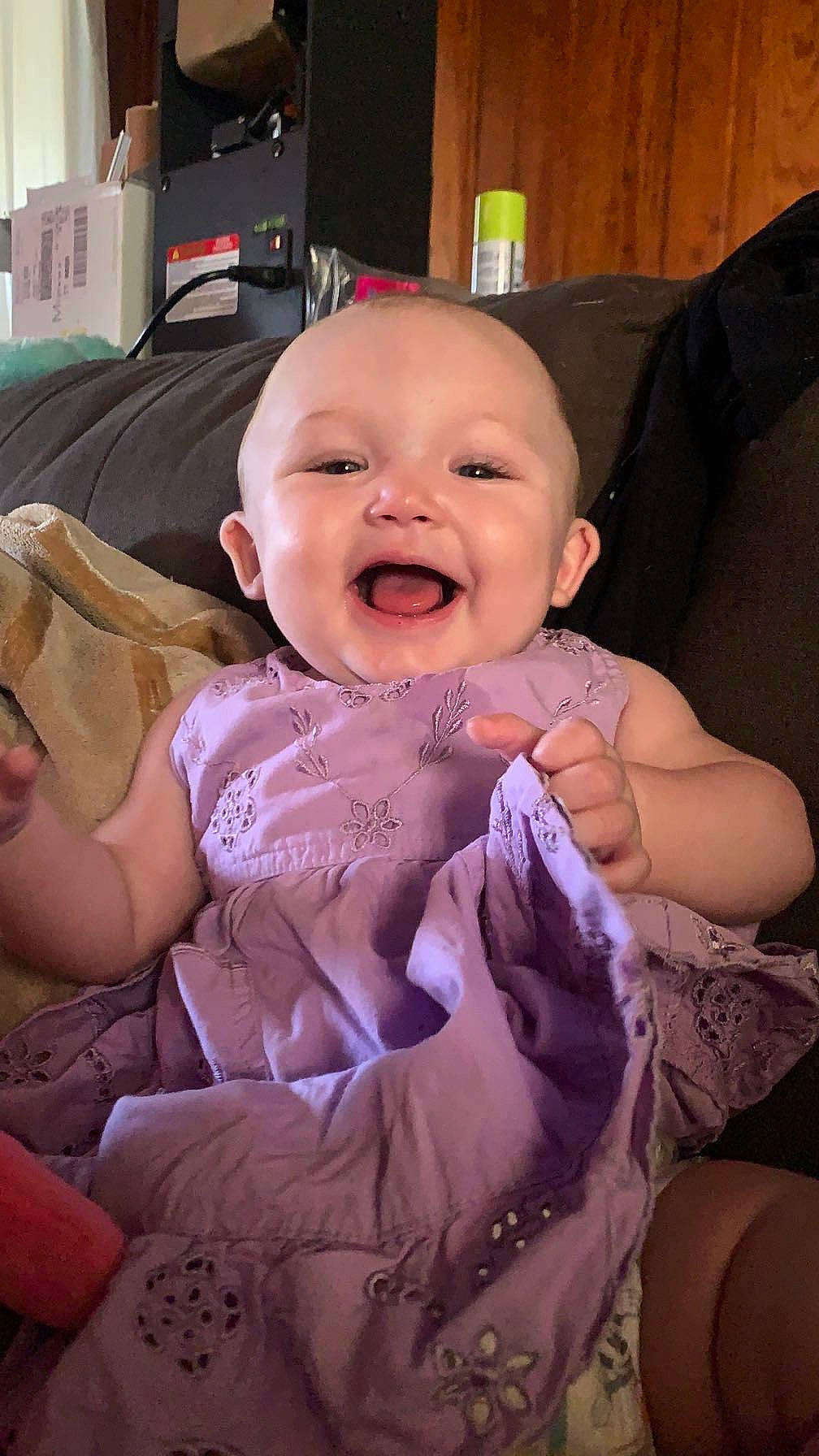 Indigo is registered to the contest to win money with this photo: abdomen, baby, baby_products, baby_toddler_clothing, cheek, child, comfort, event, fun, happy, iris, joy, lap, nail, person, pink, room, sitting, skin, smile