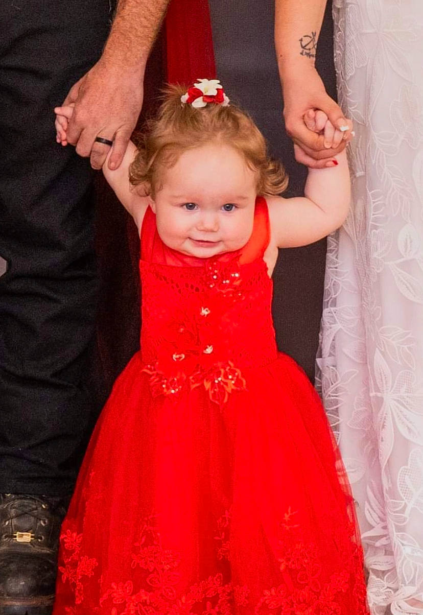 Lily joined the competition — help win amazing prizes! arm, baby, baby_toddler_clothing, bridal_party_dress, dress, face, gesture, hair, hand, happy, head, human_body, one_piece_garment, person, pink, shoulder, skin, sleeve, smile, standing