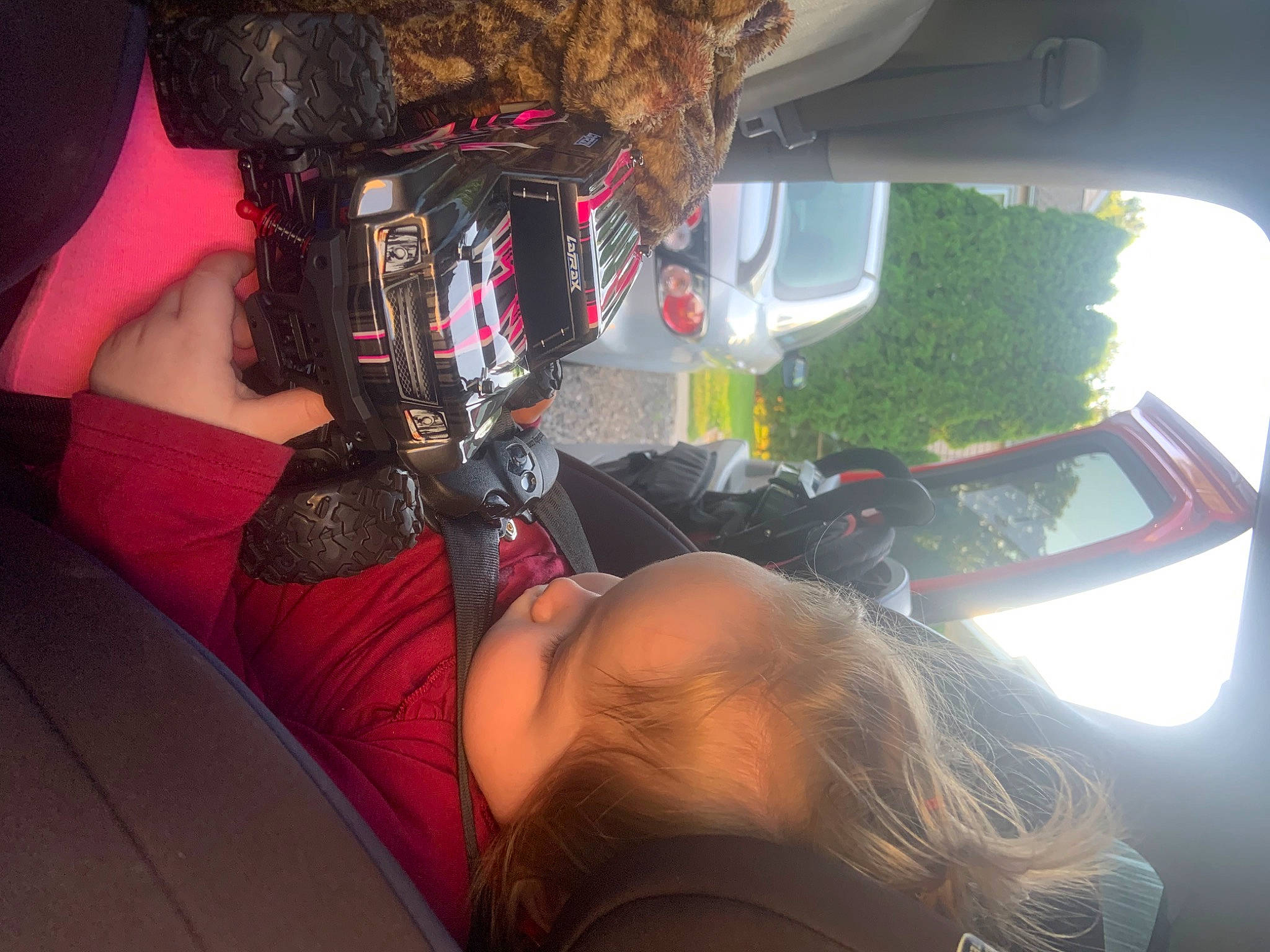 Lily joined the competition — help win amazing prizes! auto_part, automotive_design, automotive_exterior, automotive_lighting, black_hair, bumper, car, eyewear, fun, headlamp, human_body, human_leg, motor_vehicle, person, personal_protective_equipment, thigh, tree, vehicle, vehicle_door, window