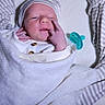 newborn, baby, infant, child, portrait, lying_down, swaddled, blanket, hat, pacifier, striped_clothing, pajamas, bed, bedding, sleeping, face, hand, cozy, indoors, family_photo