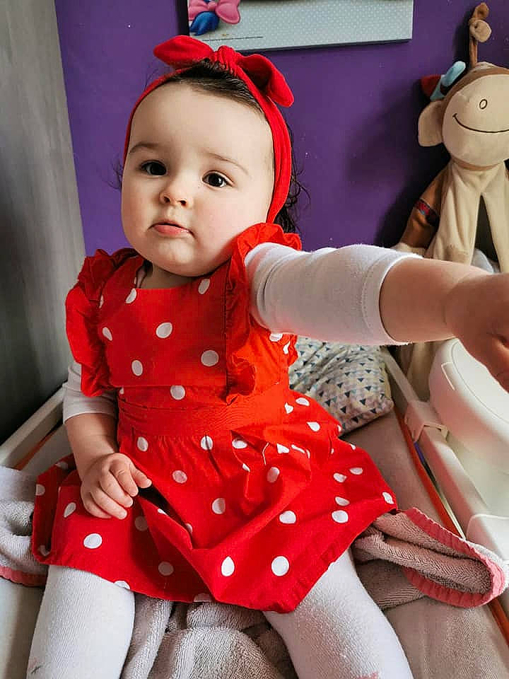 Laureline a rejoint le concours — aidez-le/la à gagner de superbes lots ! baby, baby_toddler_clothing, dress, facial_expression, finger, fun, hairstyle, happy, head, human_body, leg, outerwear, person, pink, product, skin, sleeve, standing, textile, toddler