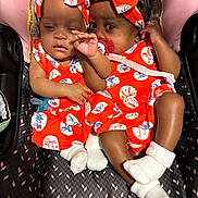 Paris London is registered to the contest to win money with this photo: adorable, baby, child, close_up, clothing, cuddling, cute, cute_babies, headband, indoors, infant, matching_outfits, newborn, orange_outfit, pacifier, person, sleepy, stroller, twin_babies, white_socks