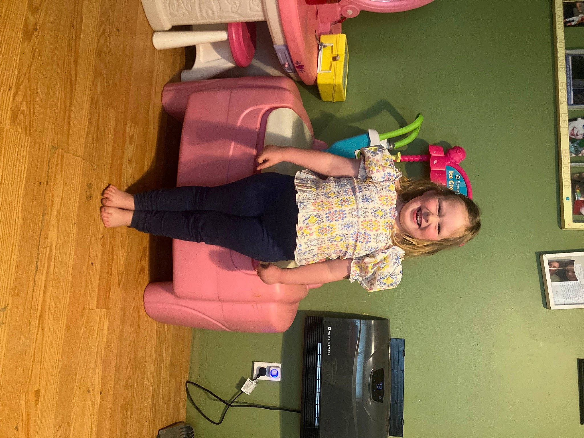 Josie is registered to the contest to win money with this photo: balance, child, flooring, fun, hardwood, hat, joy, knee, magenta, person, picture_frame, room, sandal, smile, sock, thigh, toddler, visual_arts, wood
