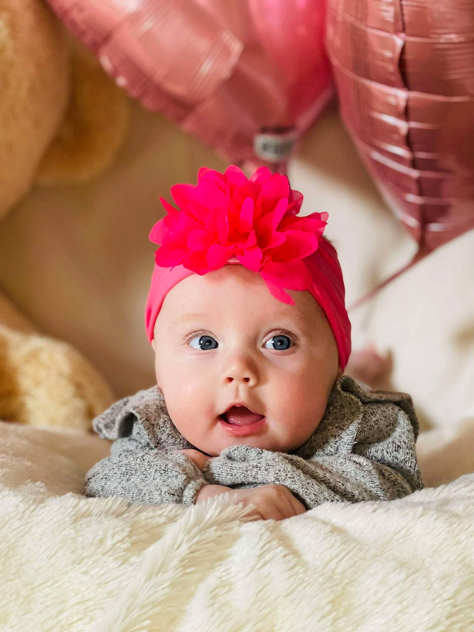 Astrid is registered to the contest to win money with this photo: baby, baby_toddler_clothing, cap, child, close_up, comfort, costume_hat, fashion_accessory, fur, hair_accessory, happy, headpiece, headwear, magenta, party_supply, peach, person, petal, pink, surprise