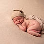 newborn, baby, sleeping, hat, knitted_hat, blanket, soft_texture, skin, infant, peaceful, cute, portrait, closeup, cozy, resting, child, naked, warm_colors, gentle_lighting, toddler