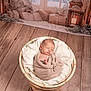 Lévy participe au concours pour gagner de l'argent avec cette photo : newborn, baby, swaddled, basket, blanket, wooden_floor, indoors, sleeping, cozy, holiday, winter, lantern, gift, decor, background, wrapped_present, soft_light, peaceful, portrait, infant