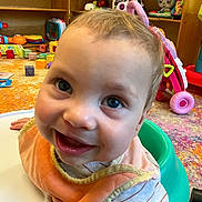 Beau joined the competition — help win amazing prizes! baby, child, smiling, blue_eyes, bib, baby_seat, toys, colorful, indoor, floor, playroom, shelves, happy, face, person, infant, clothing, closeup, cute, young