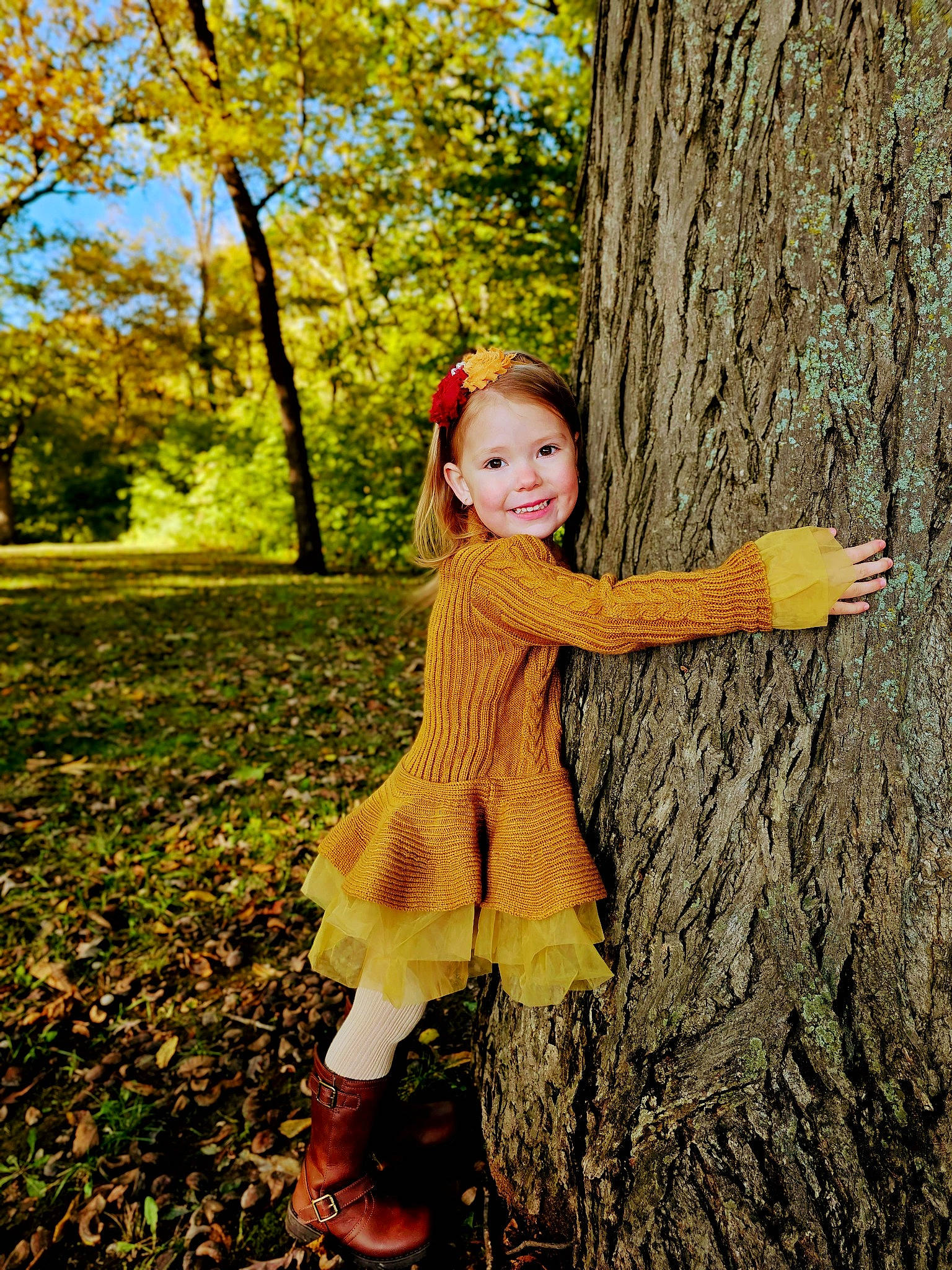 Lily joined the competition — help win amazing prizes! boot, branch, deciduous, flash_photography, forest, fun, grass, happy, joy, people_in_nature, person, plant, smile, sunlight, toddler, tree, trunk, twig, wood, woodland