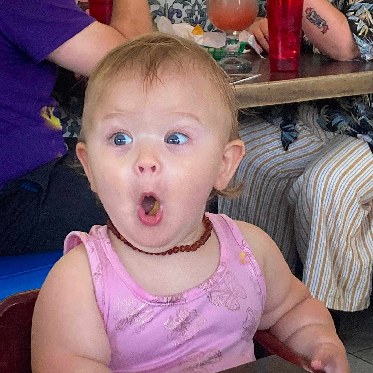 Lily is registered to the contest to win money with this photo: accessories, adult, baby, beverage, drinking, eating, face, female, food, head, jewelry, necklace, person, photobombing, photography, portrait, spitting, surprised, woman, yawning