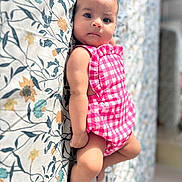 Ariella participe au concours pour gagner de l'argent avec cette photo : baby, infant, child, pink_gingham, romper, floral_bedspread, pattern, lying_down, curious, soft_light, indoor, cute, small, skin, face, eyes, arm, leg, bed, fabric