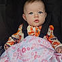 Ivy joined the competition — help win amazing prizes! baby, child, infant, stroller, blanket, face, blue_eyes, clothing, orange, pink, pattern, floral, cute, expression, person, seated, indoors, portrait, young_child, baby_clothes