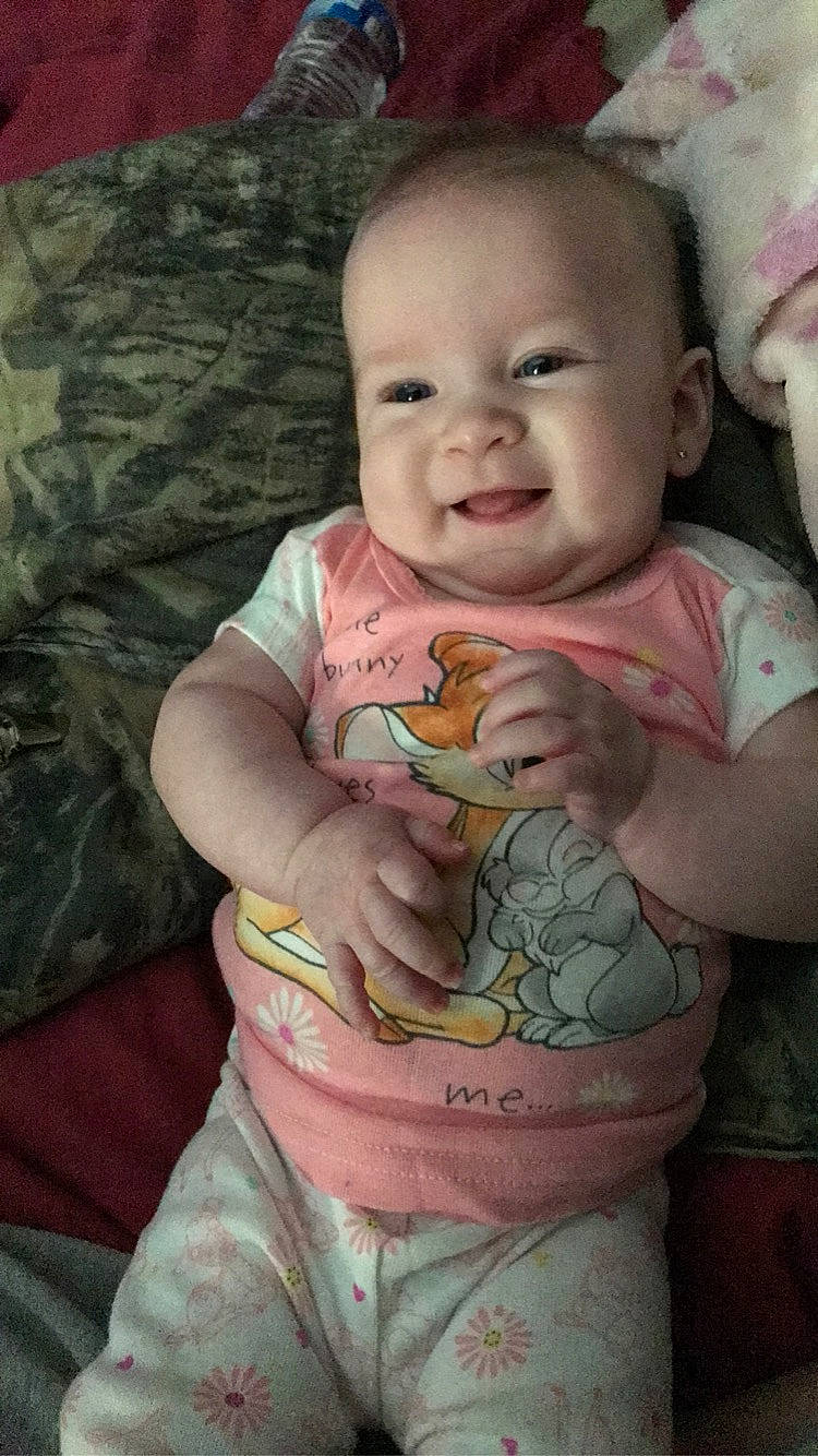 Adaline is registered to the contest to win money with this photo: baby, baby_toddler_clothing, cheek, chest, eye, face, happy, head, iris, lip, mouth, neck, nose, person, pink, skin, sleeve, smile, stomach, toddler