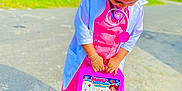 Ravisha joined the competition — help win amazing prizes! child, kid, toy, medical_kit, doctor_costume, outdoor, sidewalk, shoes, pink_clothing, white_coat, hair_bun, sunny_day, greenery, play, pretend_play, young_child, standing, casual, bright_colors, street